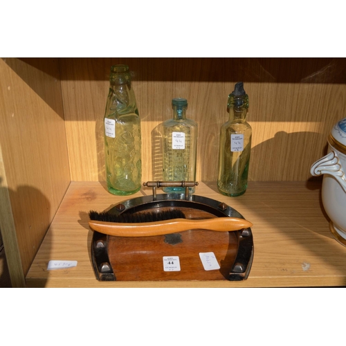 44 - A horseshoe shaped crumb tray and brush and three old bottles.