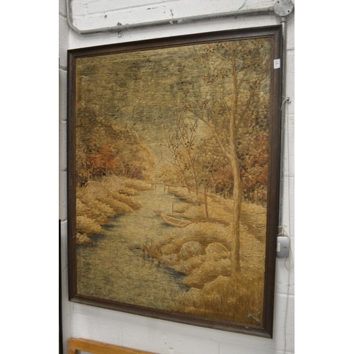 459 - A large Oriental embroidered picture of a wooded river landscape.