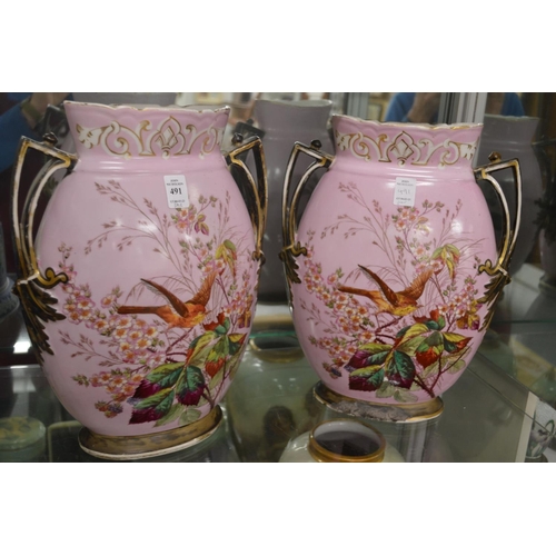 491 - A pair of large decorative twin handled vases, pink ground painted with birds and flowers.