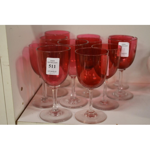 511 - A quantity of cranberry coloured wine glasses.