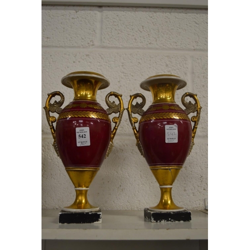 542 - A pair of gilt decorated twin handled urn shaped vases.