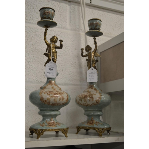 550 - A pair of decorative figural candlesticks.