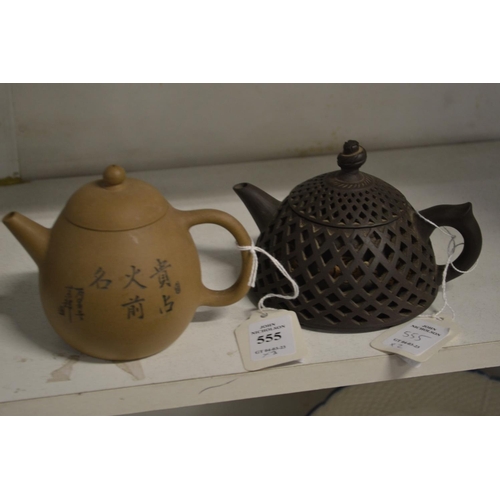 555 - Two Chinese Yixing teapots, one with reticulated body.