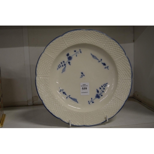 559 - A Chantilly creamware plate with basket weave border painted with blue flowers.