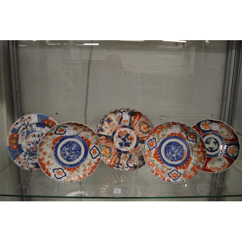 561 - A Japanese fluted imari dish, signed and four similar.