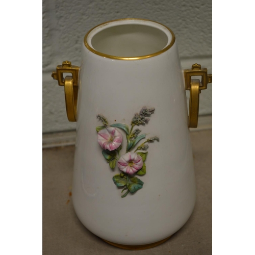 568 - A floral decorated vase and cover.