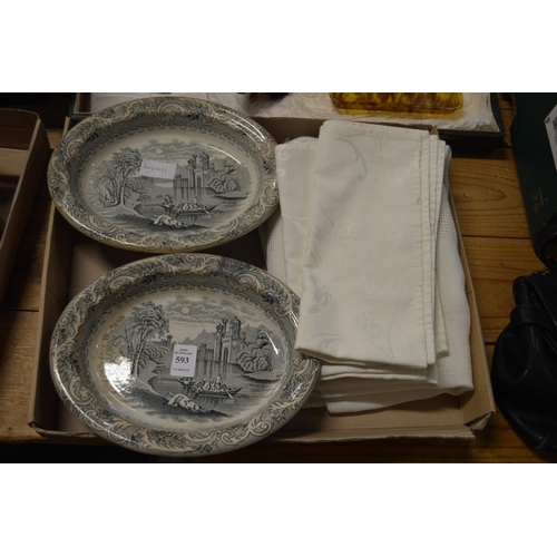 593 - A pair of pottery dishes and various linen.