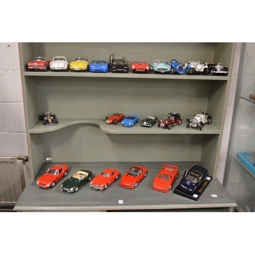 674 - A good collection of Burago model cars together with a Schuco clockwork ferrari.