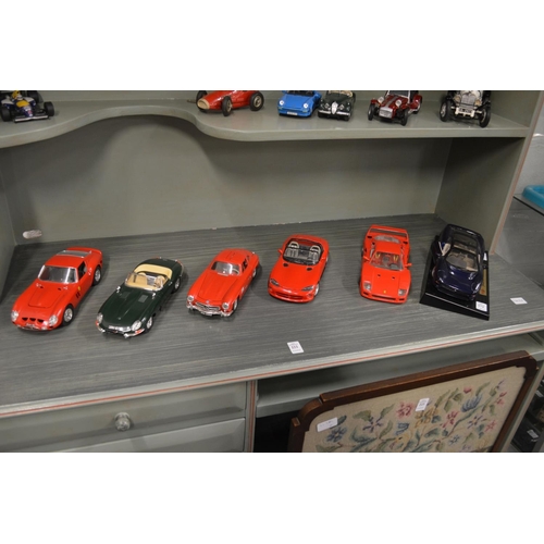 674 - A good collection of Burago model cars together with a Schuco clockwork ferrari.