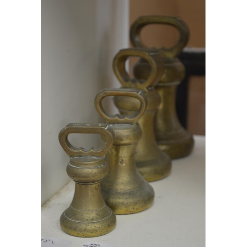 71 - A graduated set of four brass bell weights.