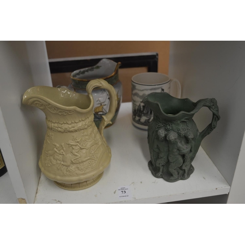 73 - Various decorative jugs and a tankard.