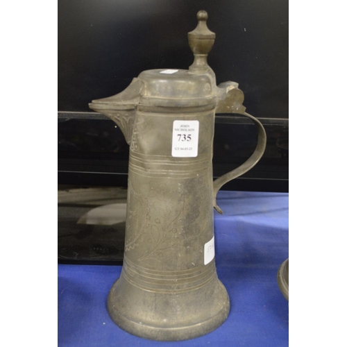 735 - A pewter lidded jug.