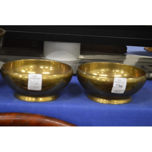 736 - A pair of heavy brass bowls.