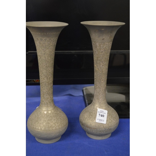 740 - A pair of Islamic metal vases.