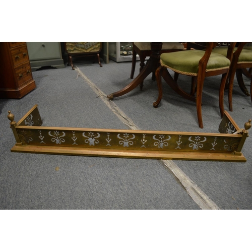 764 - A 19th century brass fender with pierced fretwork front and urn finials, 4' 2