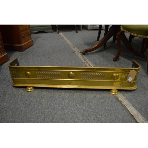 766 - A 19th century brass pierced fender on two bun feet, 3' 5