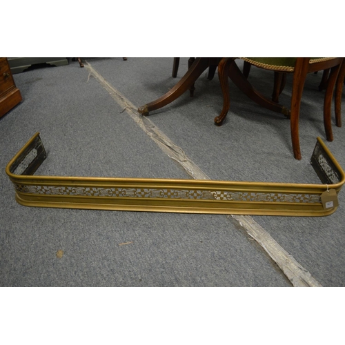 767 - A 19th century brass pierced fender on two bun feet, 3' 9