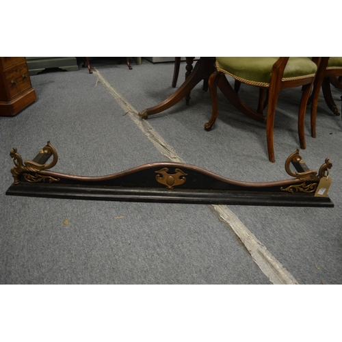 770 - A Victorian steel and cast iron serpentine shaped fender with lion ring handles, 4' 4