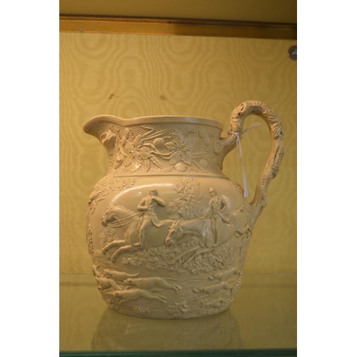 786 - A moulded hunting jug.