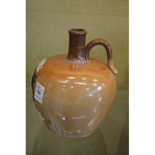 789 - A Doulton salt glazed jug with moulded decoration 'Special Highland Whisky'.