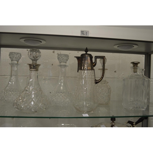 834 - Cut glass decanter with silver collar, a claret jug with plated mounts and five other decanters.