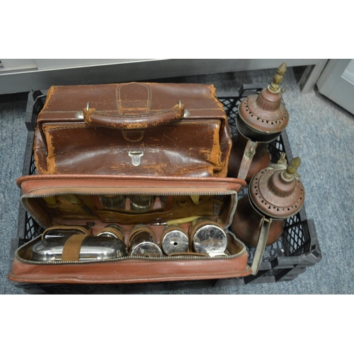 837 - Two Eastern copper ewers, a gents travelling vanity case, and a small leather doctor's bag.