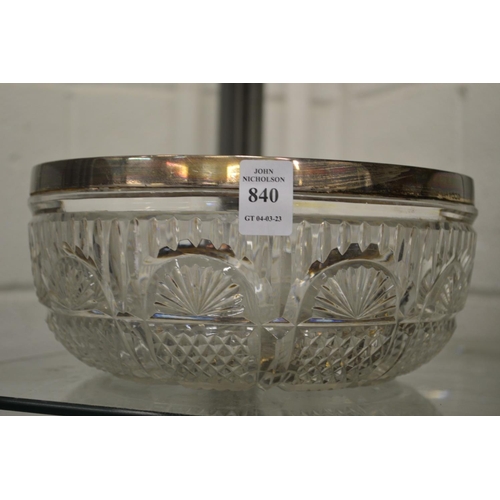 840 - A cut glass bowl with silver rim.