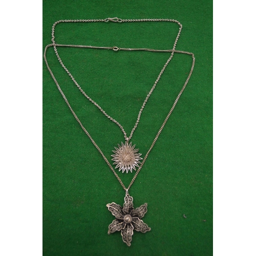 1021 - Two filigree silver flower head pendants with chains.