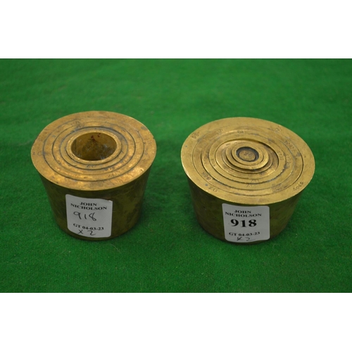 918 - A set of brass cup weights and a part set of cup weights.