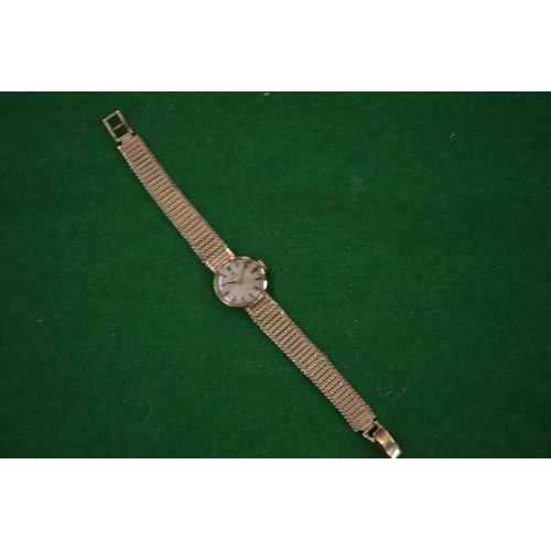 931 - A Ladies 9 carat gold Omega wristwatch with 9 carat gold strap.