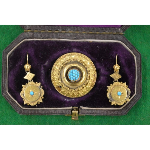 947 - A Victorian circular yellow metal brooch mounted with turquoise stones together with a pair of simil... 