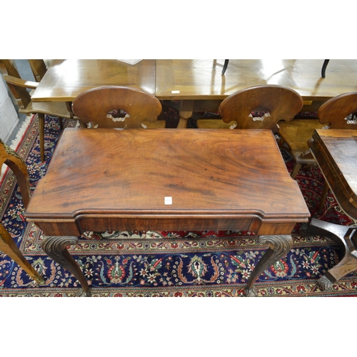 290 - A good George III mahogany fold-over card table of shaped outline on carved cabriole legs with claw ... 