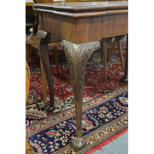 290 - A good George III mahogany fold-over card table of shaped outline on carved cabriole legs with claw ... 