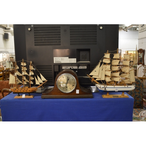 731 - Two model ships and a mantel clock.