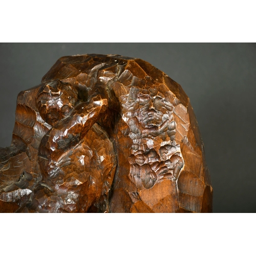 249 - A Continental wood carving of a nude male figure moving a rock bearing figureheads, circa 1900, sign... 