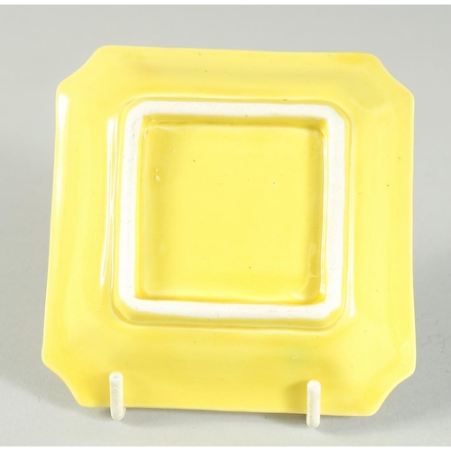 14 - A SMALL CHINESE YELLOW GLAZED SQUARE FORM DRAGON DISH, 9.5cm square.