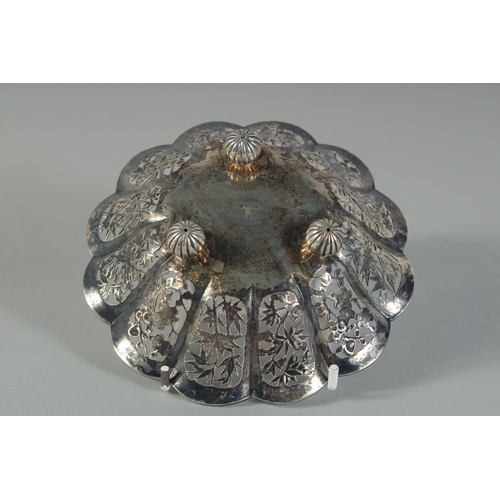16 - A SMALL CHINESE ENGRAVED AND PIERCED SILVER PETAL FORM DISH, on three ball feet, stamped to base, we... 