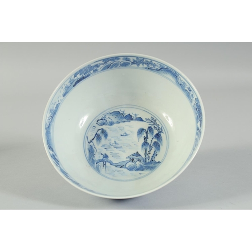 4 - AN EARLY 20TH CENTURY CHINESE BLUE AND WHITE PORCELAIN BOWL, painted with landscape scenes, with fou... 
