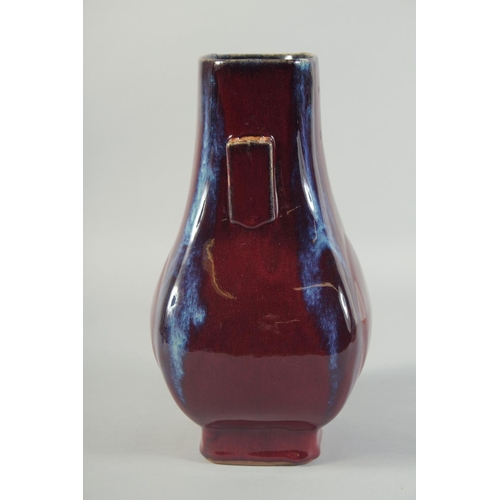 58 - A CHINESE FLAMBE GLAZE TWIN RING HANDLE VASE, 28cm high.