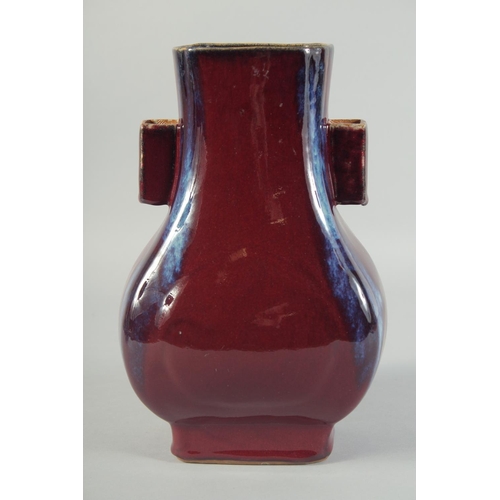 58 - A CHINESE FLAMBE GLAZE TWIN RING HANDLE VASE, 28cm high.