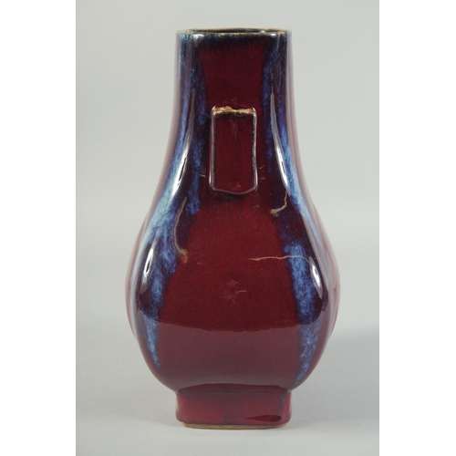 58 - A CHINESE FLAMBE GLAZE TWIN RING HANDLE VASE, 28cm high.