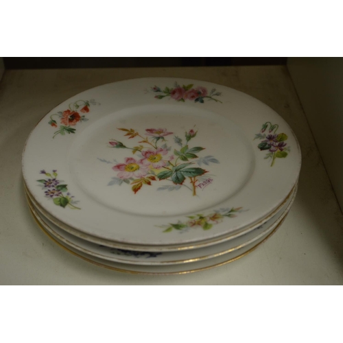 104 - A set of four Continental floral decorated porcelain plates signed Farge.