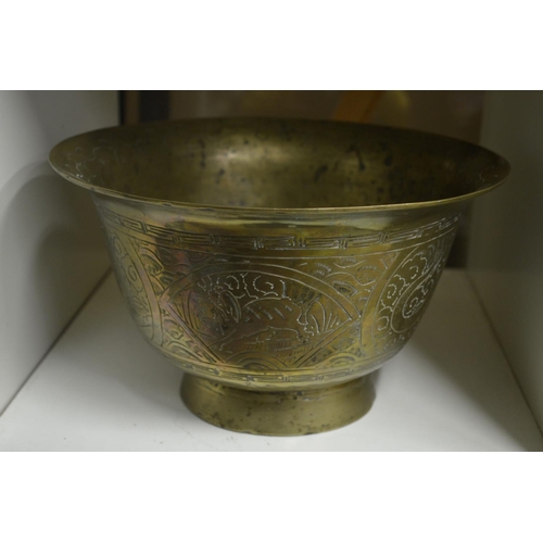 107 - An Eastern engraved brass pedestal bowl.