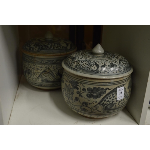 108 - Two similar Oriental blue and white pottery bowls and covers.