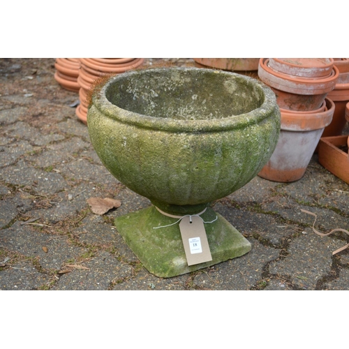 18 - A small pedestal composite garden planter.