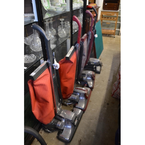 207 - Four Kirby vacuum cleaners with numerous accessories.