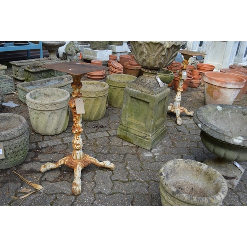 21 - A pair of painted cast iron table stands.