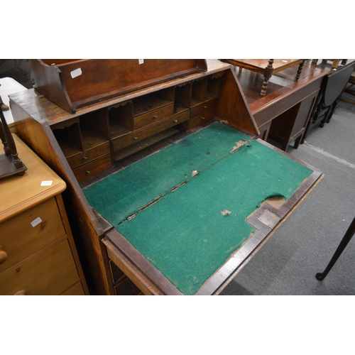 281 - A George III oak and mahogany banded bureau.