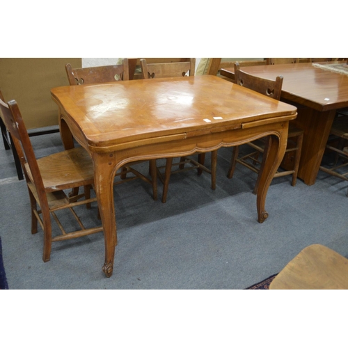 306 - A French fruitwood draw leaf dining table.