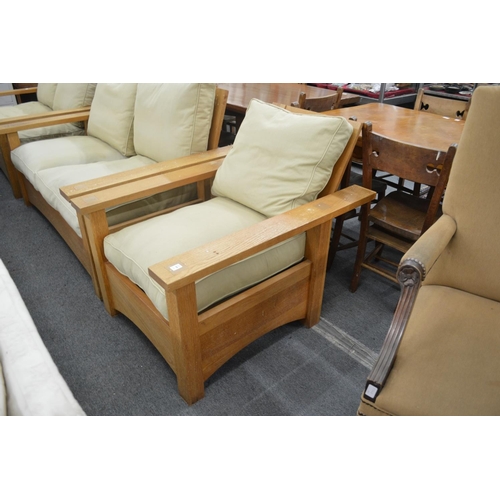 308 - In the manner of Gustav Stickley, an oak framed three piece lounge suite comprising pair of two seat... 